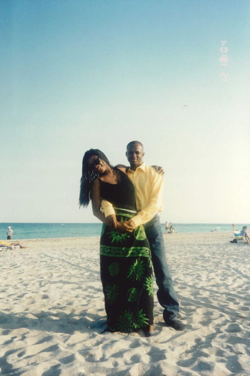 Anjola Odukoya’s father Folafumi Odukoya and mother Abena Odukoya on a beach in Miami in the early 2000s. Her Ghanaian mother draped a detailed sarong around her waist, and her father somehow managed the Miami heat in his button-up. COURTESY OF FARIDAH IBRAHIM