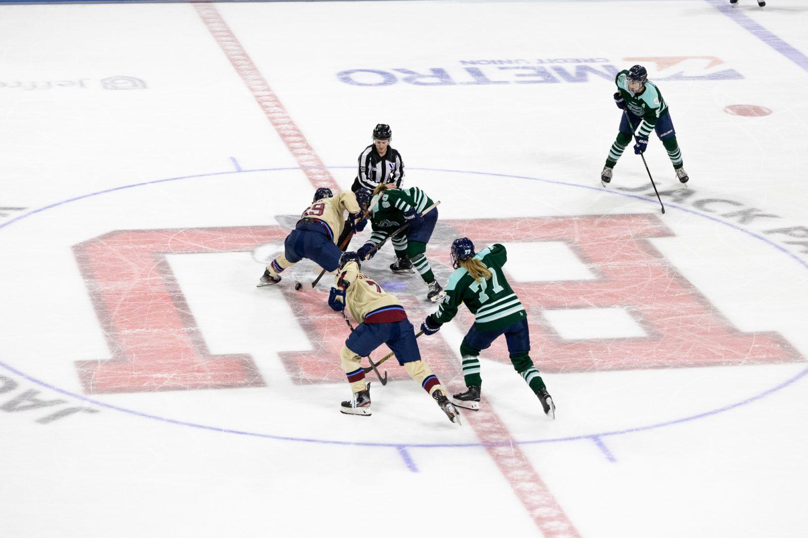 Marie-Philip Poulin (29) wins the opening face-off of overtime. 
