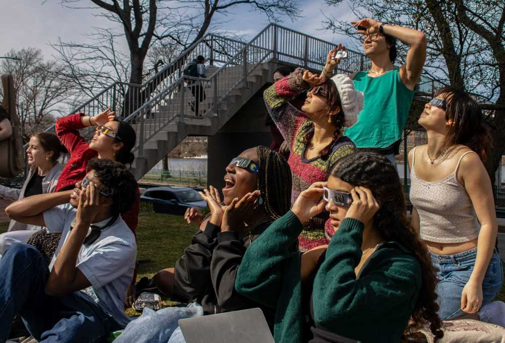 Students watch the 93% partial eclipse at BU Beach. The next solar eclipse in the United States will be in 2044 and students were eager to experience the rare occurrence. CLARE ONG/DFP PHOTOGRAPHER
